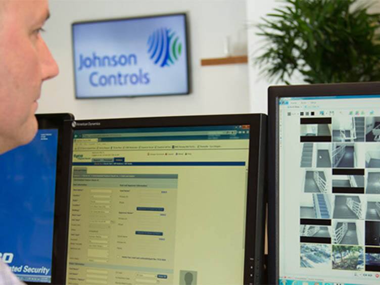 Security officer watching the surveillance cameras on screen 