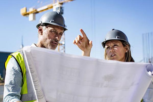 two-people-conversing-at-construction-site
