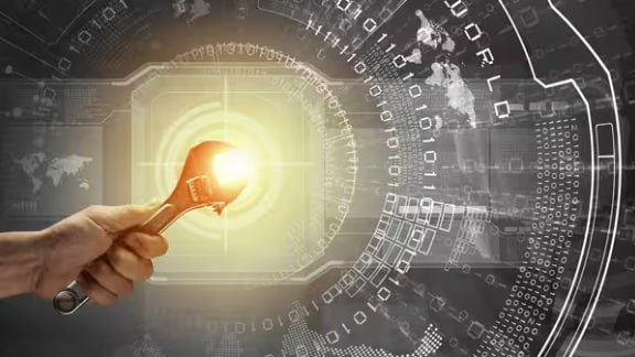 Person holding a spanner, with graphics depicting computer systems in the background