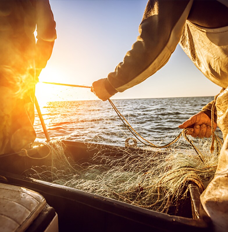 Men casting a fish-net into the sea